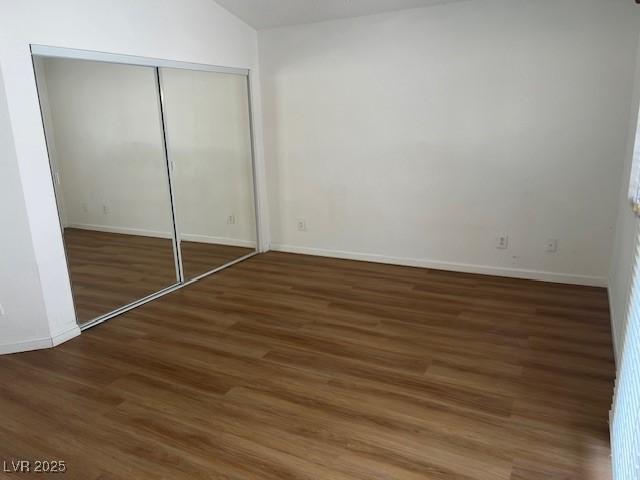 9600 Pacific View Dr, Las Vegas, NV 89117 - unfurnished bedroom featuring wood finished floors, a closet, and vaulted ceiling