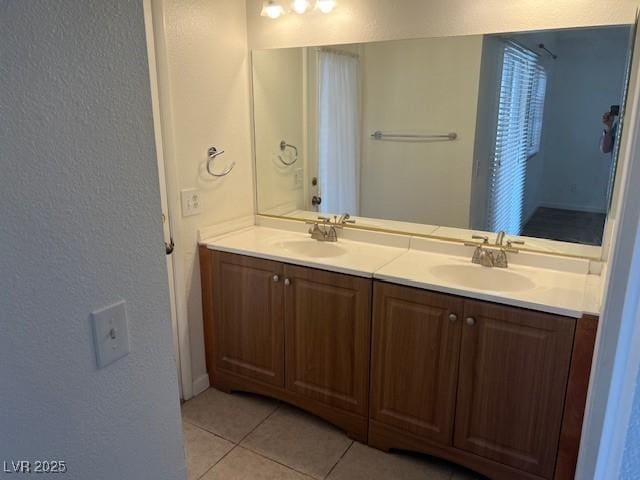 9600 Pacific View Dr, Las Vegas, NV 89117 - full bath featuring a textured wall, double vanity, and tile patterned floors