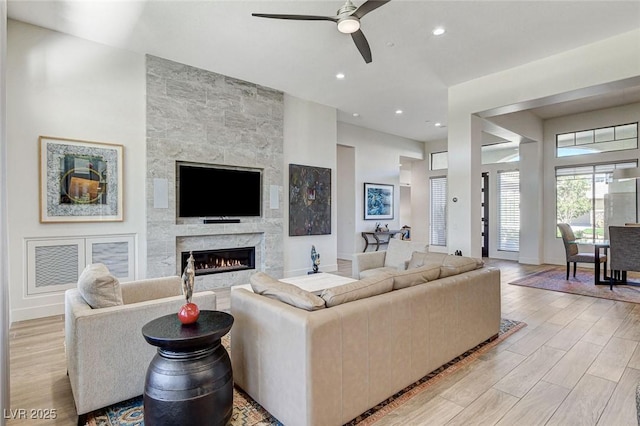 33 Hassayampa Trl, Henderson, NV 89052 - living room featuring ceiling fan, light wood finished floors, a high end fireplace, and recessed lighting