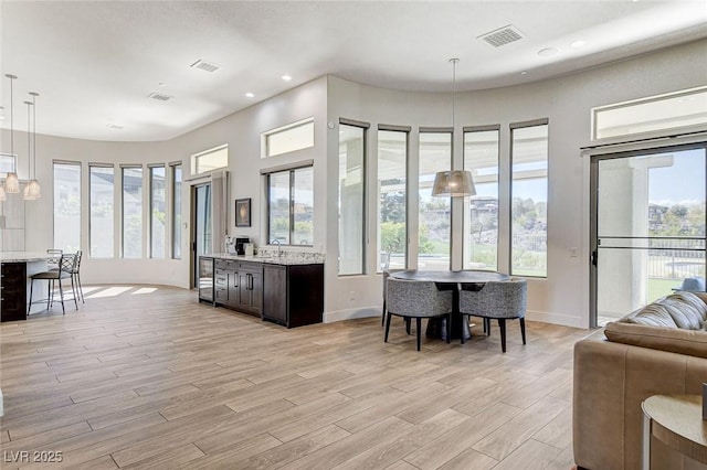 33 Hassayampa Trl, Henderson, NV 89052 - kitchen with open floor plan, plenty of natural light, light wood-style flooring, hanging light fixtures, and recessed lighting