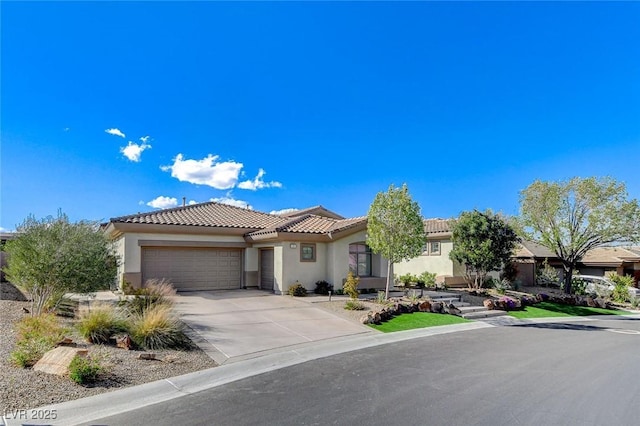 33 Hassayampa Trl, Henderson, NV 89052 - mediterranean / spanish-style house featuring stucco siding, an attached garage, a tile roof, and concrete driveway