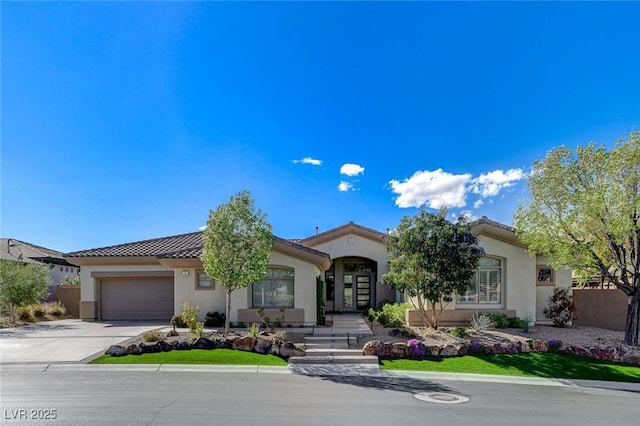 33 Hassayampa Trl, Henderson, NV 89052 - mediterranean / spanish-style house featuring concrete driveway, stucco siding, a tiled roof, and a garage