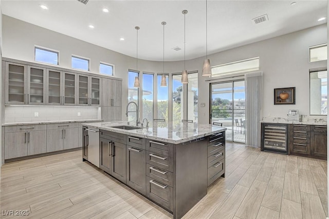 33 Hassayampa Trl, Henderson, NV 89052 - kitchen featuring dishwasher, light wood-style flooring, glass insert cabinets, wine cooler, and recessed lighting