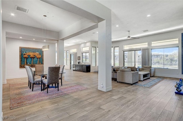 33 Hassayampa Trl, Henderson, NV 89052 - dining area with light wood finished floors, healthy amount of natural light, recessed lighting, a wall mounted AC, and a ceiling fan