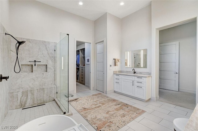 33 Hassayampa Trl, Henderson, NV 89052 - full bathroom featuring a stall shower, vanity, a walk in closet, tile patterned flooring, and recessed lighting
