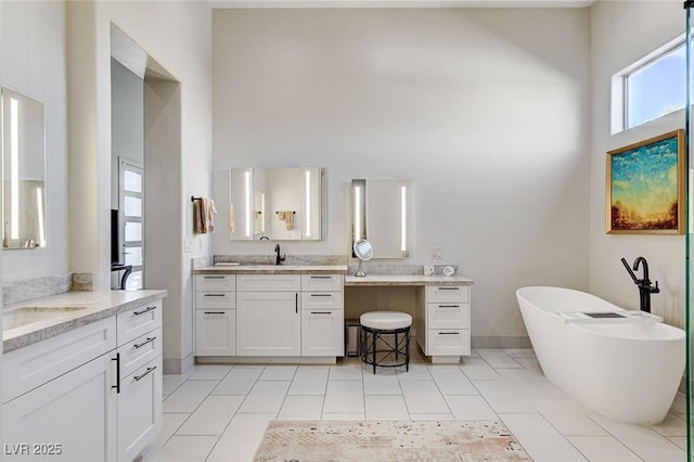 33 Hassayampa Trl, Henderson, NV 89052 - bathroom featuring a high ceiling, two vanities, a soaking tub, and tile patterned flooring