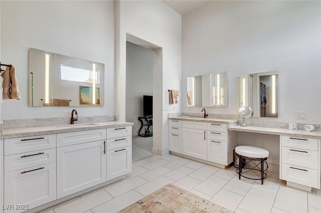 33 Hassayampa Trl, Henderson, NV 89052 - bathroom featuring a high ceiling, two vanities, and tile patterned flooring