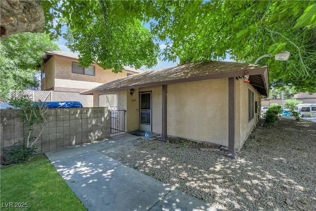 5083 Village Dr, Las Vegas, NV 89142 - rear view of property featuring a gate and stucco siding