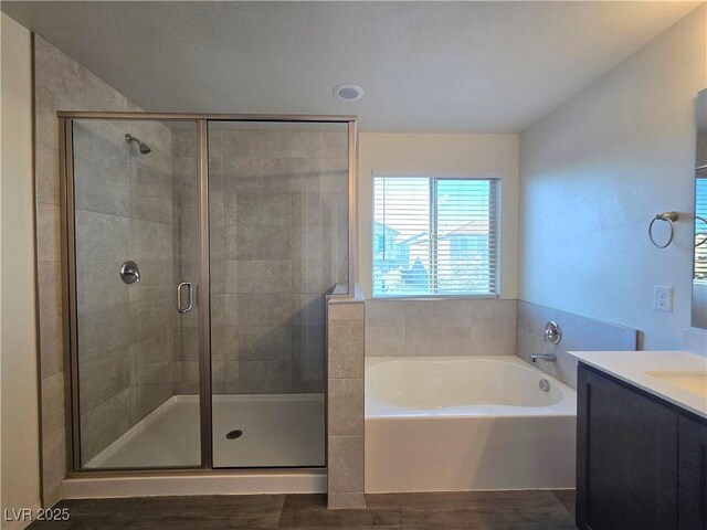 5817 Bonita Rose St, Las Vegas, NV 89113 - full bath featuring vanity, a bath, wood finished floors, and a shower stall