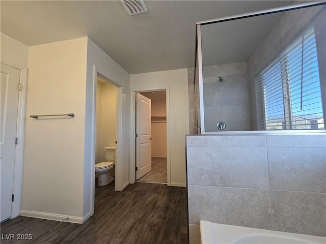 5817 Bonita Rose St, Las Vegas, NV 89113 - full bathroom featuring a tile shower, wood finished floors, a walk in closet, and a bathtub