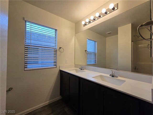 5817 Bonita Rose St, Las Vegas, NV 89113 - full bathroom featuring double vanity, wood finished floors, and a shower
