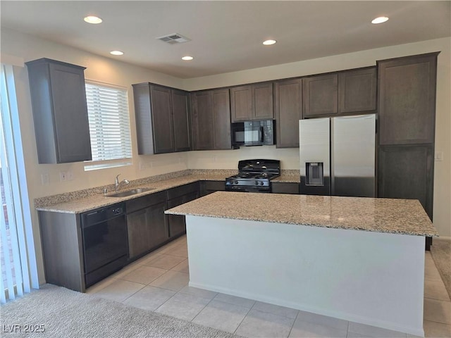 5817 Bonita Rose St, Las Vegas, NV 89113 - kitchen featuring black appliances, dark brown cabinets, recessed lighting, light stone countertops, and a center island