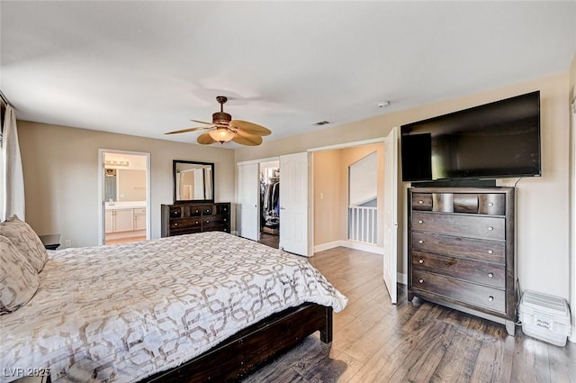 7813 Falconwing Ave, Las Vegas, NV 89131 - bedroom featuring wood finished floors, ensuite bathroom, ceiling fan, a spacious closet, and a closet
