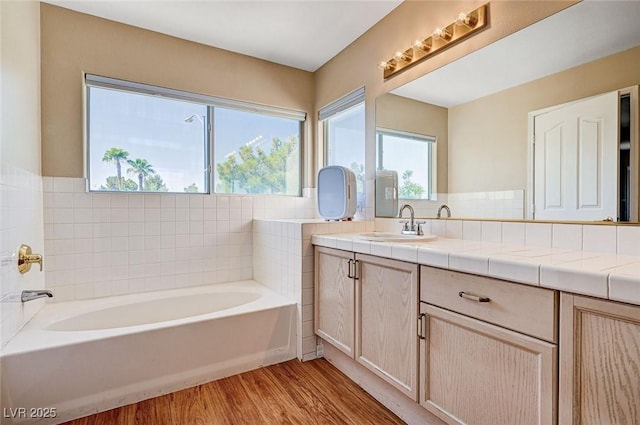 7813 Falconwing Ave, Las Vegas, NV 89131 - bathroom with a garden tub, vanity, and wood finished floors