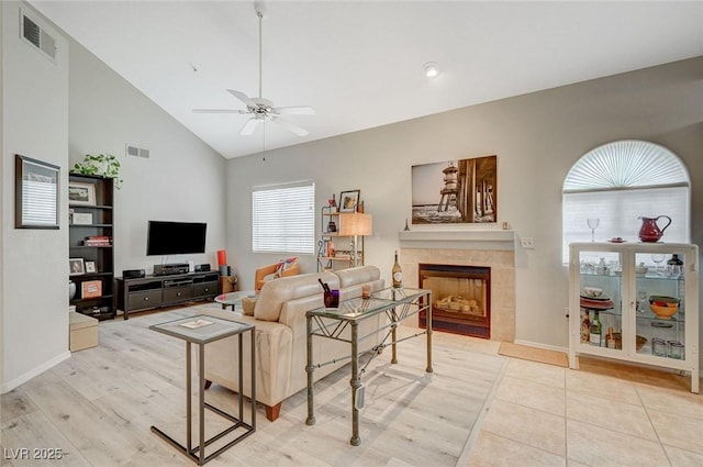 2925 Wigwam Pkwy Unit 123, Henderson, NV 89074 - living room featuring a ceiling fan, a tiled fireplace, and high vaulted ceiling