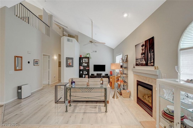 2925 Wigwam Pkwy Unit 123, Henderson, NV 89074 - living area with ceiling fan, a fireplace, wood finished floors, and high vaulted ceiling