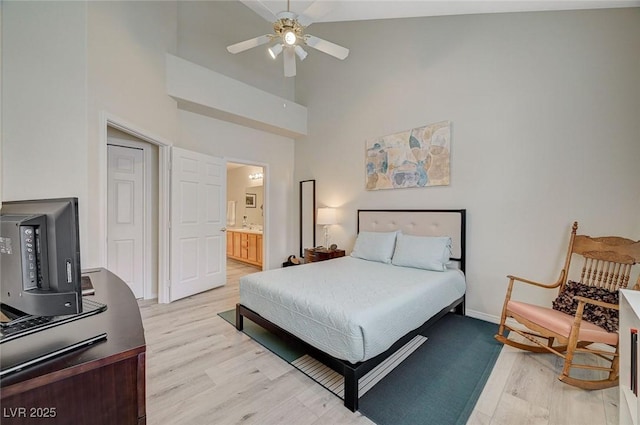 2925 Wigwam Pkwy Unit 123, Henderson, NV 89074 - bedroom featuring light wood-type flooring, a high ceiling, ensuite bath, and ceiling fan