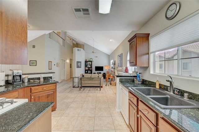 2925 Wigwam Pkwy Unit 123, Henderson, NV 89074 - kitchen featuring light tile patterned floors, ceiling fan, open floor plan, dark stone counters, and white dishwasher