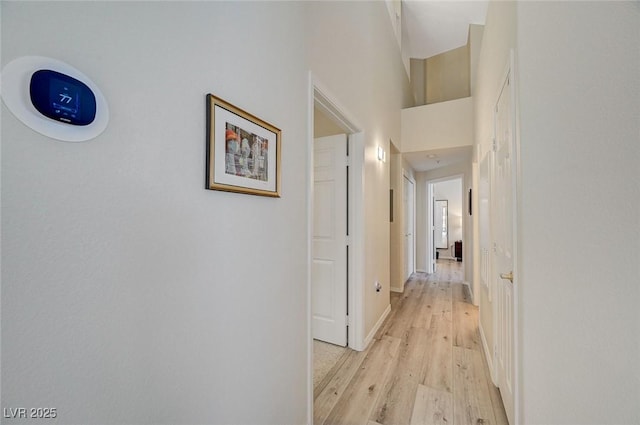 2925 Wigwam Pkwy Unit 123, Henderson, NV 89074 - hallway featuring light wood finished floors and a towering ceiling