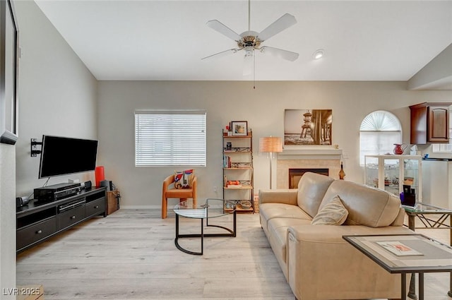 2925 Wigwam Pkwy Unit 123, Henderson, NV 89074 - living area featuring ceiling fan, light wood finished floors, and a tiled fireplace