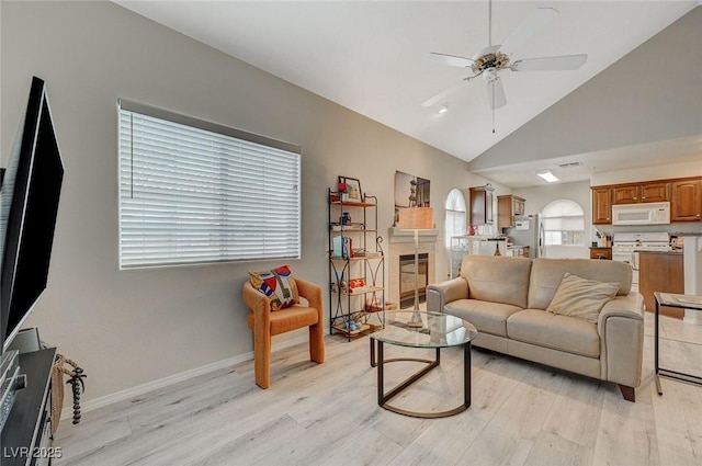 2925 Wigwam Pkwy Unit 123, Henderson, NV 89074 - living room featuring ceiling fan, healthy amount of natural light, light wood finished floors, and high vaulted ceiling