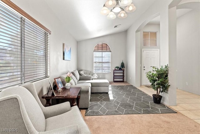 4916 White Jade St, North Las Vegas, NV 89081 - living area with arched walkways, a chandelier, carpet, and lofted ceiling