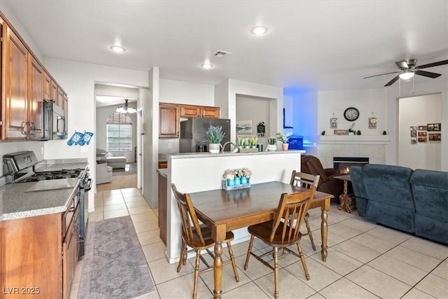 4916 White Jade St, North Las Vegas, NV 89081 - dining space featuring light tile patterned flooring, a fireplace, ceiling fan, and recessed lighting