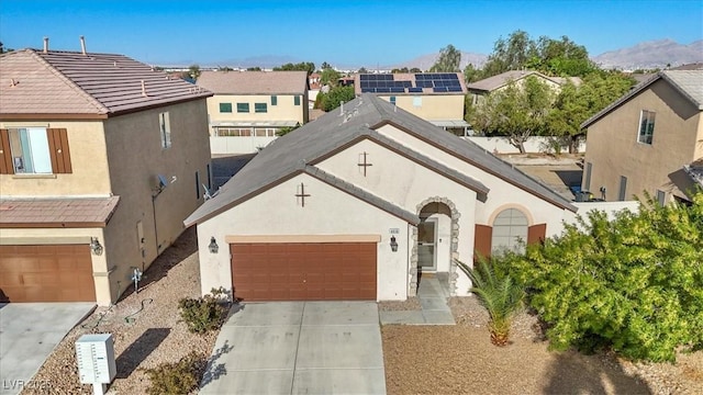 4916 White Jade St, North Las Vegas, NV 89081 - view of front of home featuring stucco siding, driveway, a mountain view, a garage, and a residential view