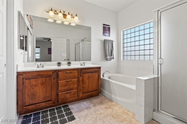 4916 White Jade St, North Las Vegas, NV 89081 - bathroom featuring a garden tub, a stall shower, double vanity, and ceiling fan
