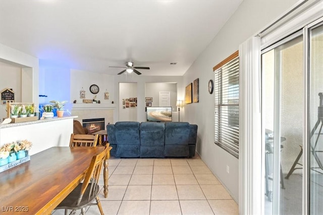 4916 White Jade St, North Las Vegas, NV 89081 - dining room with a ceiling fan, a glass covered fireplace, and light tile patterned floors