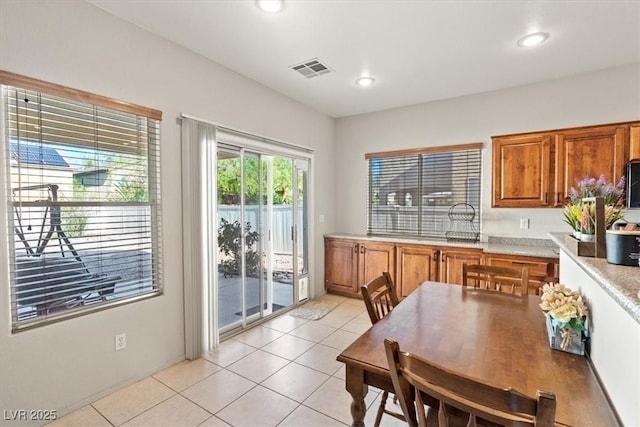 4916 White Jade St, North Las Vegas, NV 89081 - kitchen featuring light countertops, brown cabinets, light tile patterned floors, and recessed lighting