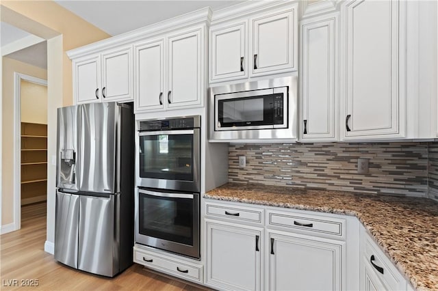 12168 Dorada Coast Ave, Las Vegas, NV 89138 - kitchen with appliances with stainless steel finishes, backsplash, and white cabinets