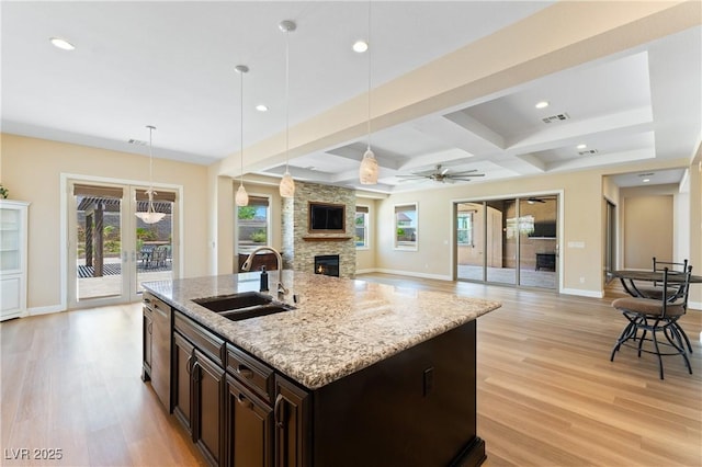 12168 Dorada Coast Ave, Las Vegas, NV 89138 - kitchen featuring a fireplace, light wood-style floors, recessed lighting, open floor plan, and healthy amount of natural light