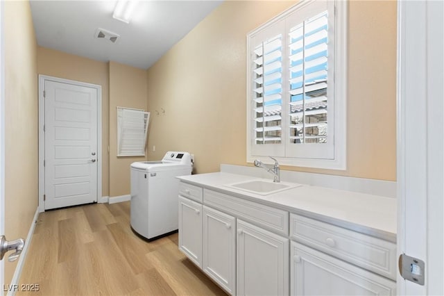 12168 Dorada Coast Ave, Las Vegas, NV 89138 - laundry room with light wood finished floors, cabinet space, and washer and dryer