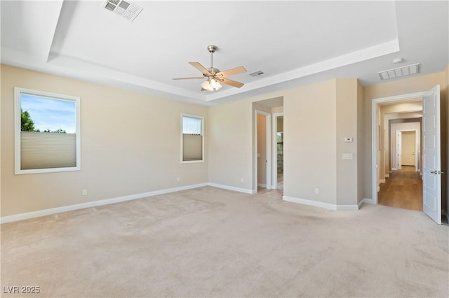 12168 Dorada Coast Ave, Las Vegas, NV 89138 - unfurnished bedroom with a raised ceiling, light colored carpet, and multiple windows