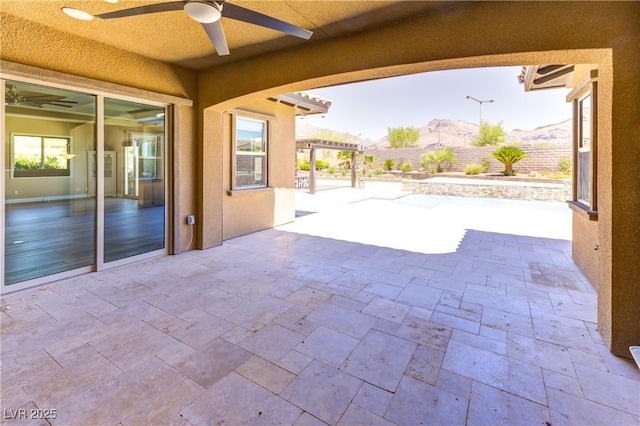 12168 Dorada Coast Ave, Las Vegas, NV 89138 - fenced backyard with ceiling fan, a patio, and a pergola