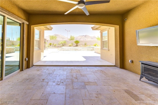 12168 Dorada Coast Ave, Las Vegas, NV 89138 - fenced backyard with ceiling fan and a patio area