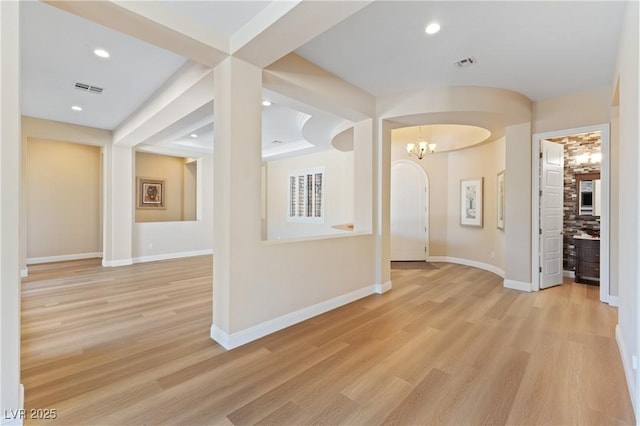 12168 Dorada Coast Ave, Las Vegas, NV 89138 - hallway with light wood-type flooring, a chandelier, arched walkways, and recessed lighting