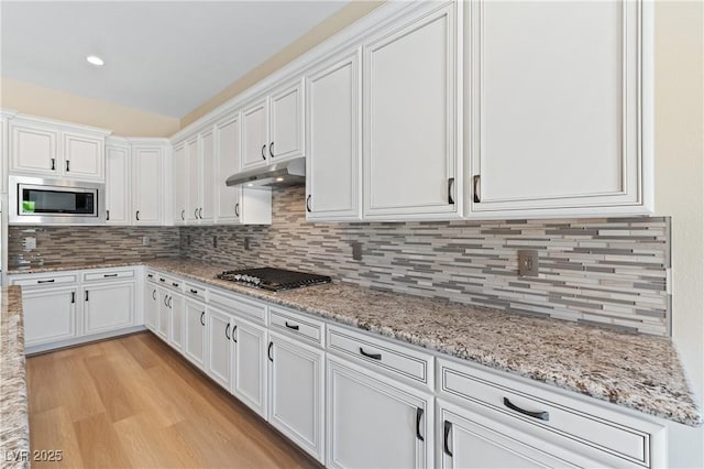 12168 Dorada Coast Ave, Las Vegas, NV 89138 - kitchen with stainless steel appliances, white cabinetry, and light wood-style floors