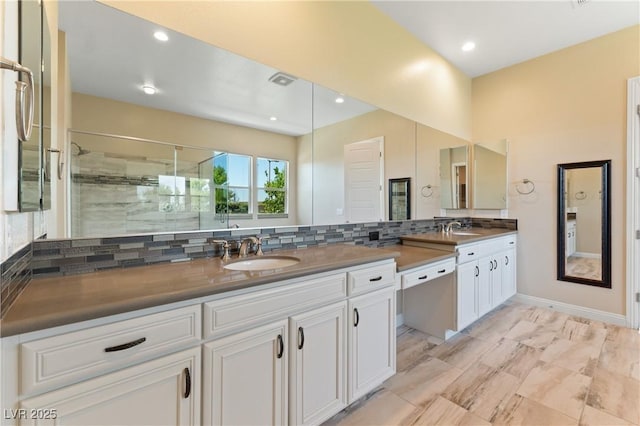 12168 Dorada Coast Ave, Las Vegas, NV 89138 - bathroom with double vanity, tasteful backsplash, a shower stall, and recessed lighting