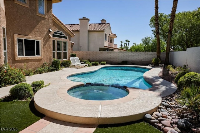 2208 Fiero Dr, Las Vegas, NV 89134 - view of swimming pool with a pool with connected hot tub and a fenced backyard