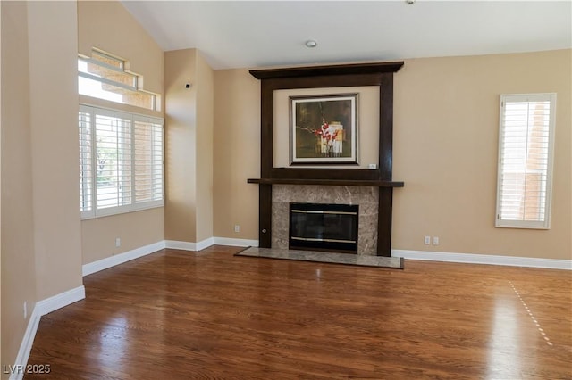 2208 Fiero Dr, Las Vegas, NV 89134 - unfurnished living room with wood finished floors, a premium fireplace, and vaulted ceiling