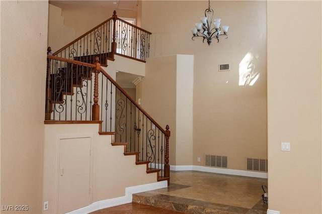 2208 Fiero Dr, Las Vegas, NV 89134 - stairs featuring a high ceiling and a chandelier