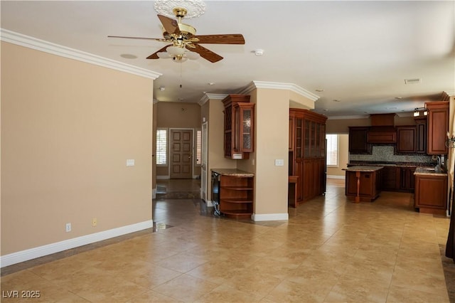 2208 Fiero Dr, Las Vegas, NV 89134 - unfurnished living room featuring a ceiling fan, ornamental molding, and light tile patterned flooring