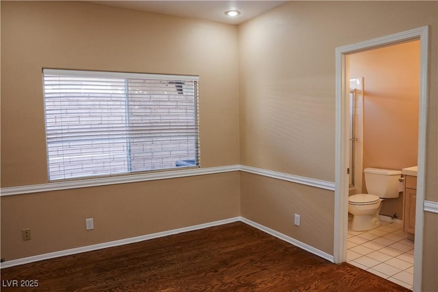 2208 Fiero Dr, Las Vegas, NV 89134 - spare room featuring dark wood-type flooring and baseboards