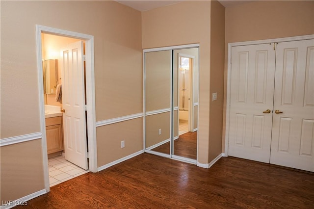 2208 Fiero Dr, Las Vegas, NV 89134 - unfurnished bedroom with wood finished floors and ensuite bath