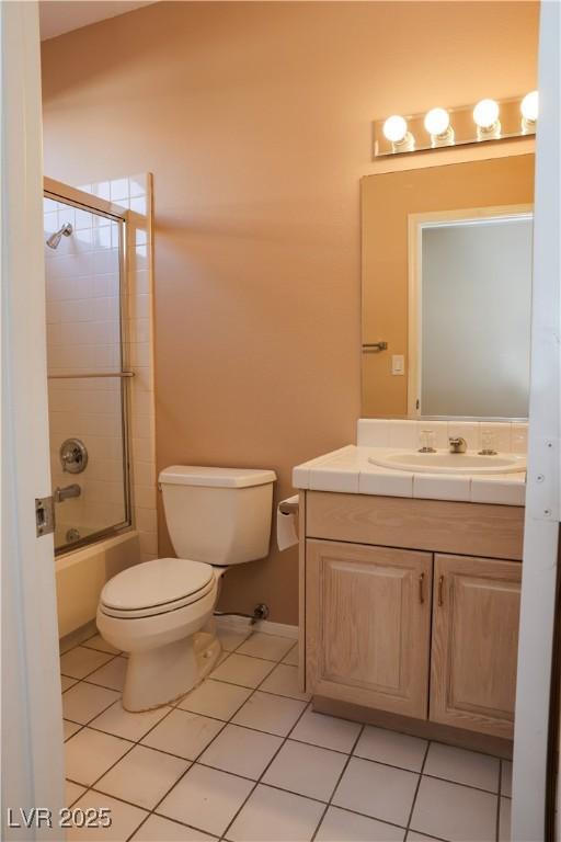 2208 Fiero Dr, Las Vegas, NV 89134 - bathroom with vanity, tile patterned flooring, and enclosed tub / shower combo