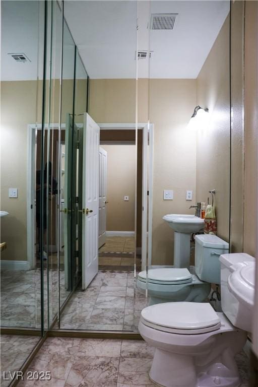2208 Fiero Dr, Las Vegas, NV 89134 - bathroom with marble look tile flooring and a bidet