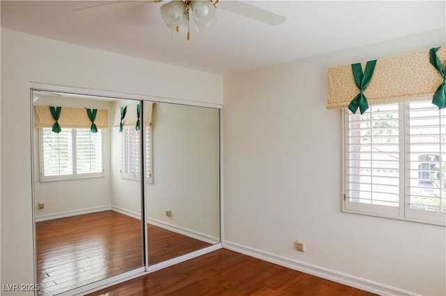 2208 Fiero Dr, Las Vegas, NV 89134 - unfurnished bedroom featuring multiple windows, wood finished floors, a closet, and ceiling fan