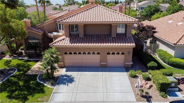 2208 Fiero Dr, Las Vegas, NV 89134 - mediterranean / spanish home with concrete driveway, stucco siding, a tile roof, and a residential view